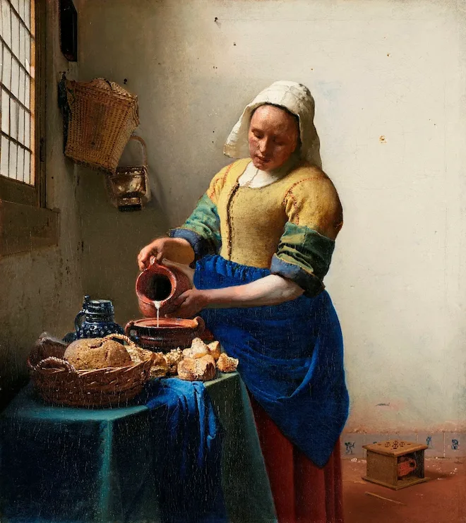 woman pouring milk from earthen jar