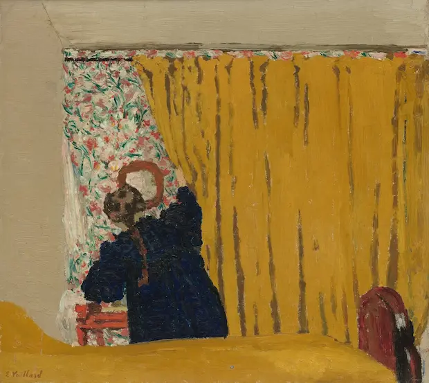 woman looking behind a dark yellow curtain