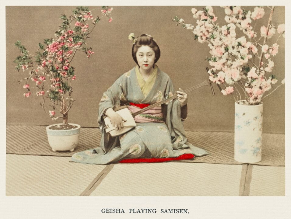 Geisha Playing Samisen, hand–colored albumen silver print from Japan. Described and Illustrated by the Japanese (1897) by Kazumasa Ogawa.
